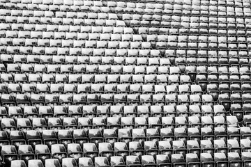 Naklejka premium Row of seats black and white image at stadium background and texture.