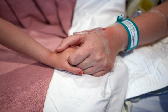 Hospital Patient Holding Child's Hand