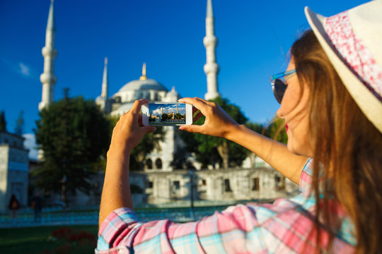 Girl  making photo by the smartphone near the Blue Mosque, Istan