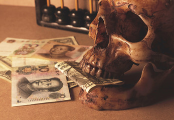 skull with banknote yuan and dollar business still life