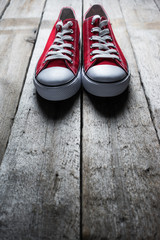  red sneakers on wooden background