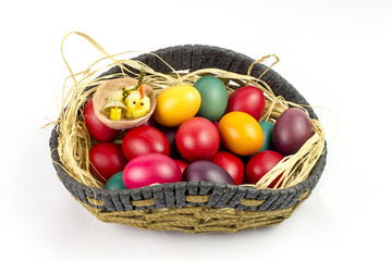 Colorfull easter eggs in a basket isolated on white