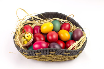 Colorfull easter eggs in a basket isolated on white