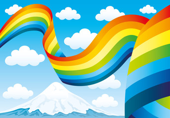 Rainbow and clouds in the blue sky above the mountain