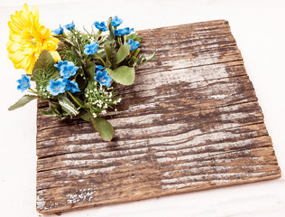 Cloth flowers on wooden table.