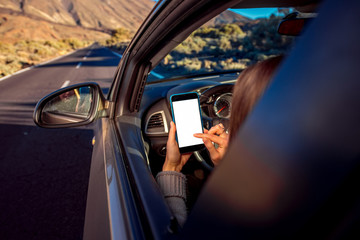 Woman using smartphone in the car