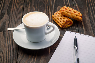 Coffee and Note Padon old wood background 