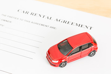 Car Rental Agreement With Red Car at Bottom Right Corner