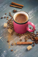 Obraz na płótnie Canvas Cup of coffee with cinnamon, coffee beans and spices