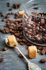 Coffee beans and brown sugar on a vintage background