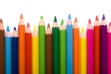 Assortment of coloured pencils with shadow on white background