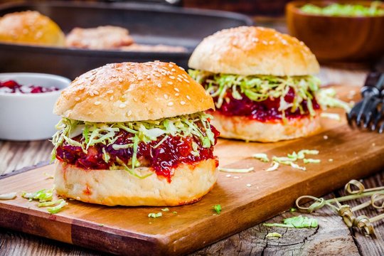 Burgers with a cutlet of turkey, cranberry sauce and salad