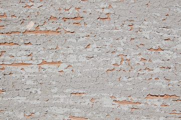Cracked paint on a wooden wall. Wall with paint traces.