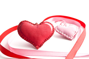 textile Valentine surrounded by red and pink ribbon