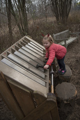 A child playing a xylophone while visiting the Everett Children's Adventure Garden within the NY Botanic Gardens New York USA