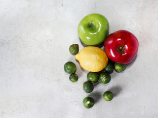 Three color of apples and lemon on vintage gray background