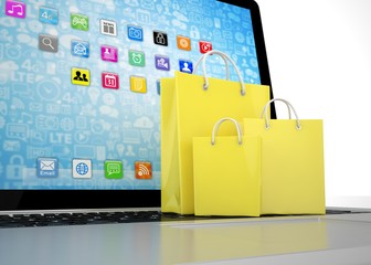 laptop and  shopping pags on white background