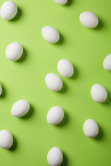 easter white eggs on green background
