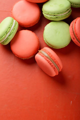 macaroons with caramel on red background