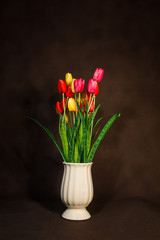Red and Yellow and Pink tulips flower in pot on vintage backgrou
