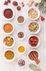 Various spices, dried and fresh herbs on table