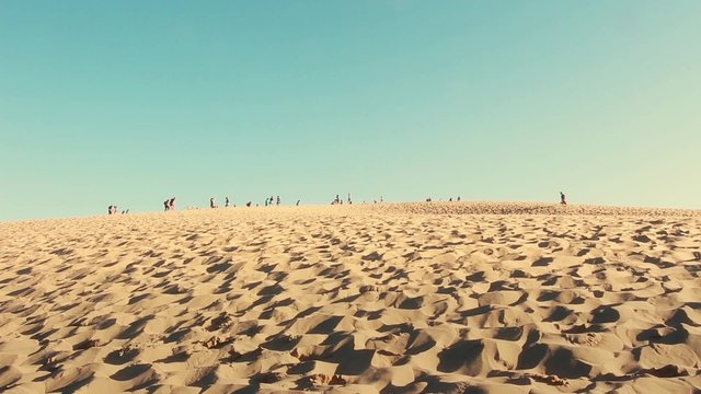 Great Dune of Pyla the tallest sand dune in europe, France. The Dune of Pyla with tourists passing by - The highest sand dune of Europe - full HD