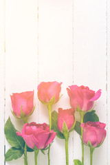 Overhead view of beautiful roses on wood table