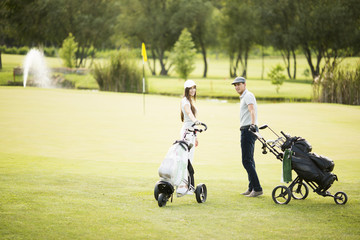Young couple at golf cart
