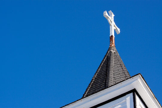 church steeple with blue sky and cross