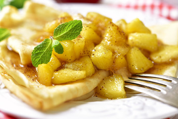 Thin pancakes with caramelised apples and cinnamon.