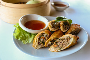 Fried vegetable spring rolls served with sweet chili sauce