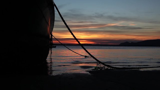abandoned boat on the beach sunset