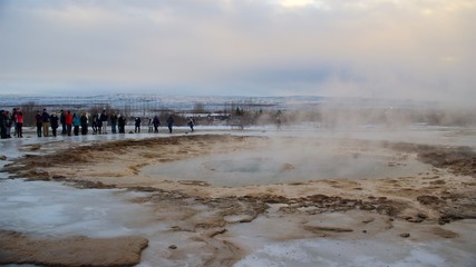Tourists waiting for the eruption of Strokkur Geyser in Iceland on January 2016.