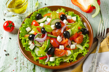 Greek salad with fresh vegetables, feta cheese and black olives