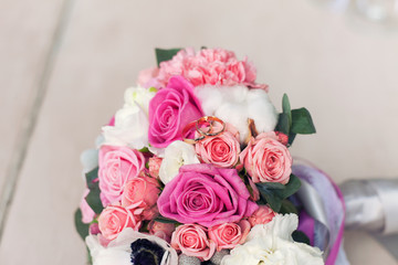 wedding rings on a bouquet of roses