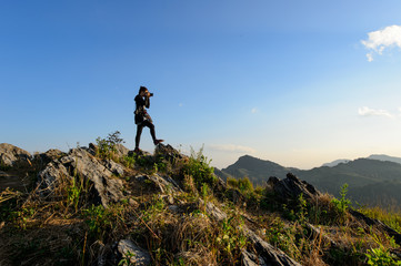 Girl taking photo on summit