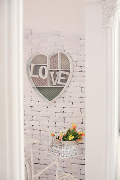 decorative frame with an inscription love on a wall