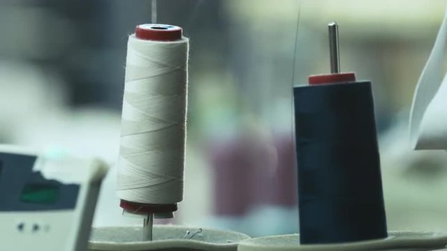 Close-up shot of cotton threads for sewing machine in action. Shot on RED Cinema Camera.