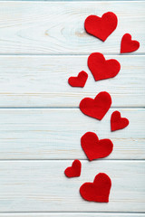 Red hearts on a blue wooden table