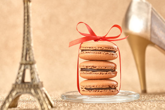 Macarons. Luxury shiny shoes, Eiffel Tower on gold