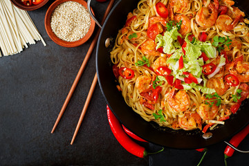 Udon pasta with shrimp, tomatoes and paprika. Top view