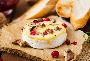 Baked cheese Camembert with cranberries and nuts