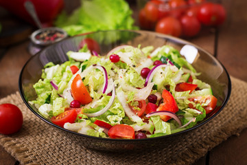 Dietary salad with fresh vegetables (tomato, cucumber, Chinese cabbage, red onion and cranberries)
