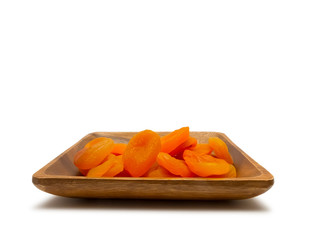 Dried apricots in wooden bowl