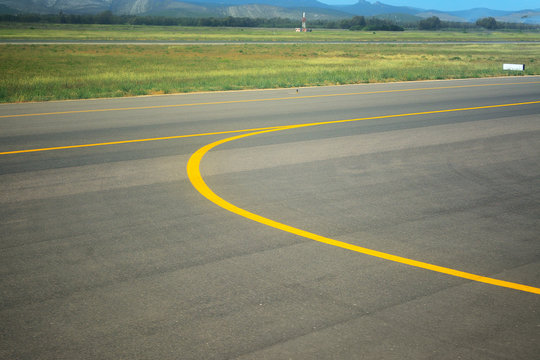 yellow line on an airport taxiway