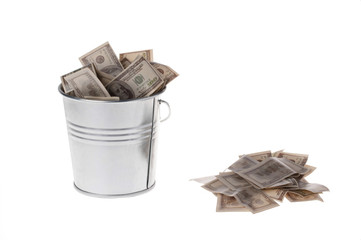 dollars in a metal bucket © Yomka