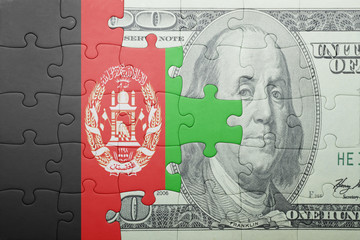 puzzle with the national flag of afghanistan and dollar banknote