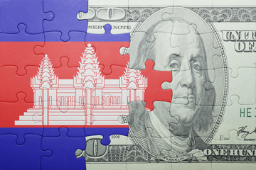 puzzle with the national flag of cambodia and dollar banknote