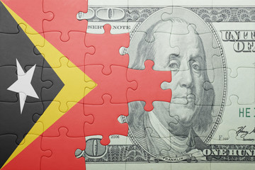 puzzle with the national flag of east timor and dollar banknote