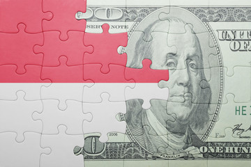puzzle with the national flag of indonesia and dollar banknote